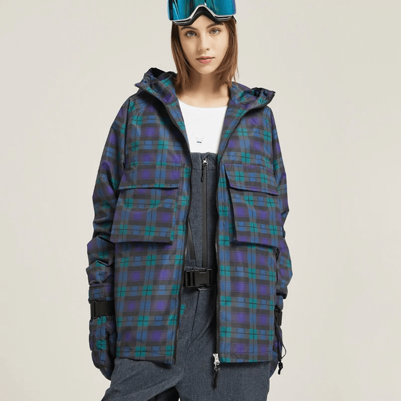 Woman wearing a warm plaid skiing jacket with large pockets and a hood, perfect for cold weather outdoor activities.